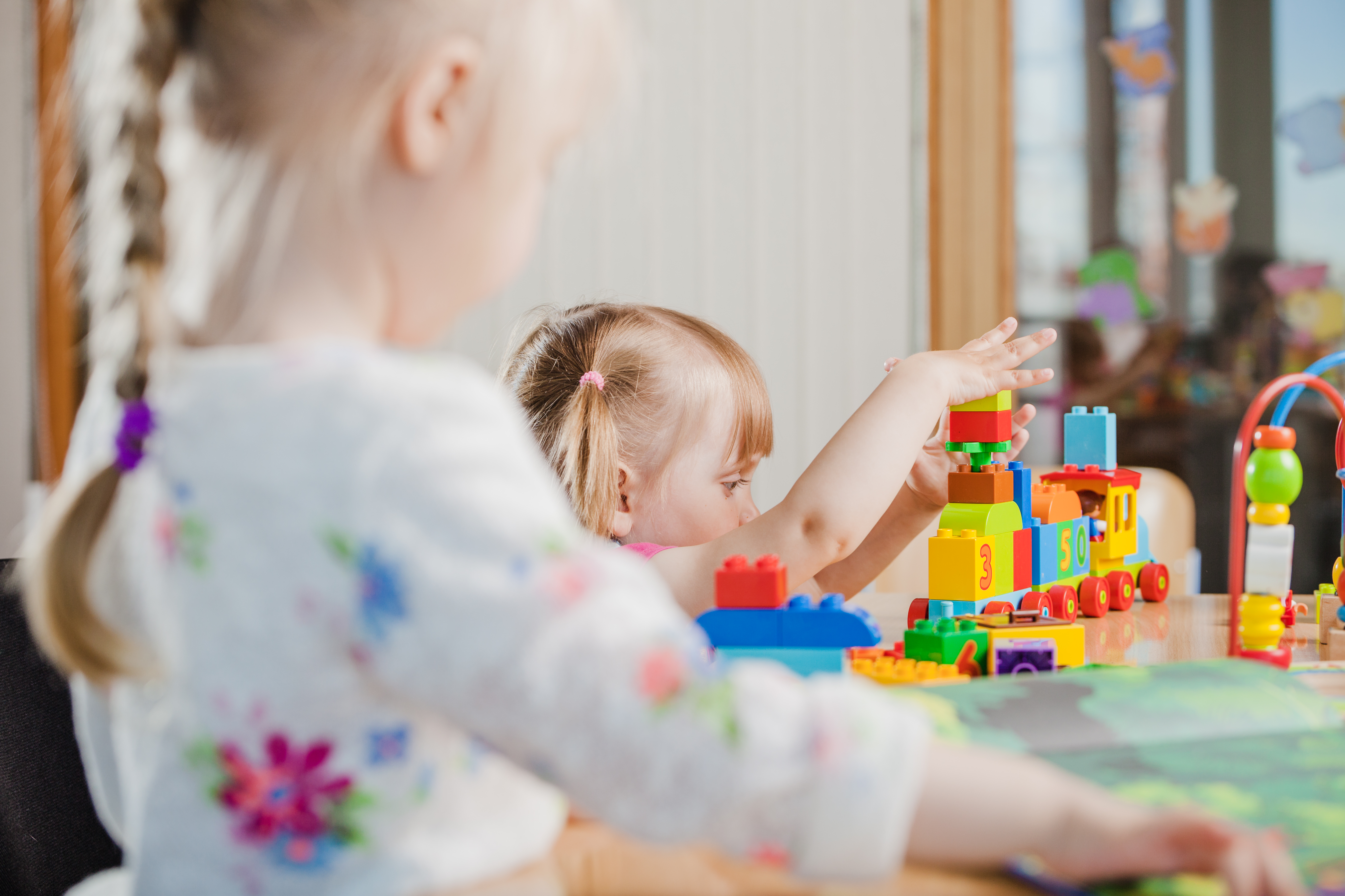 toddler playing with toy constructor